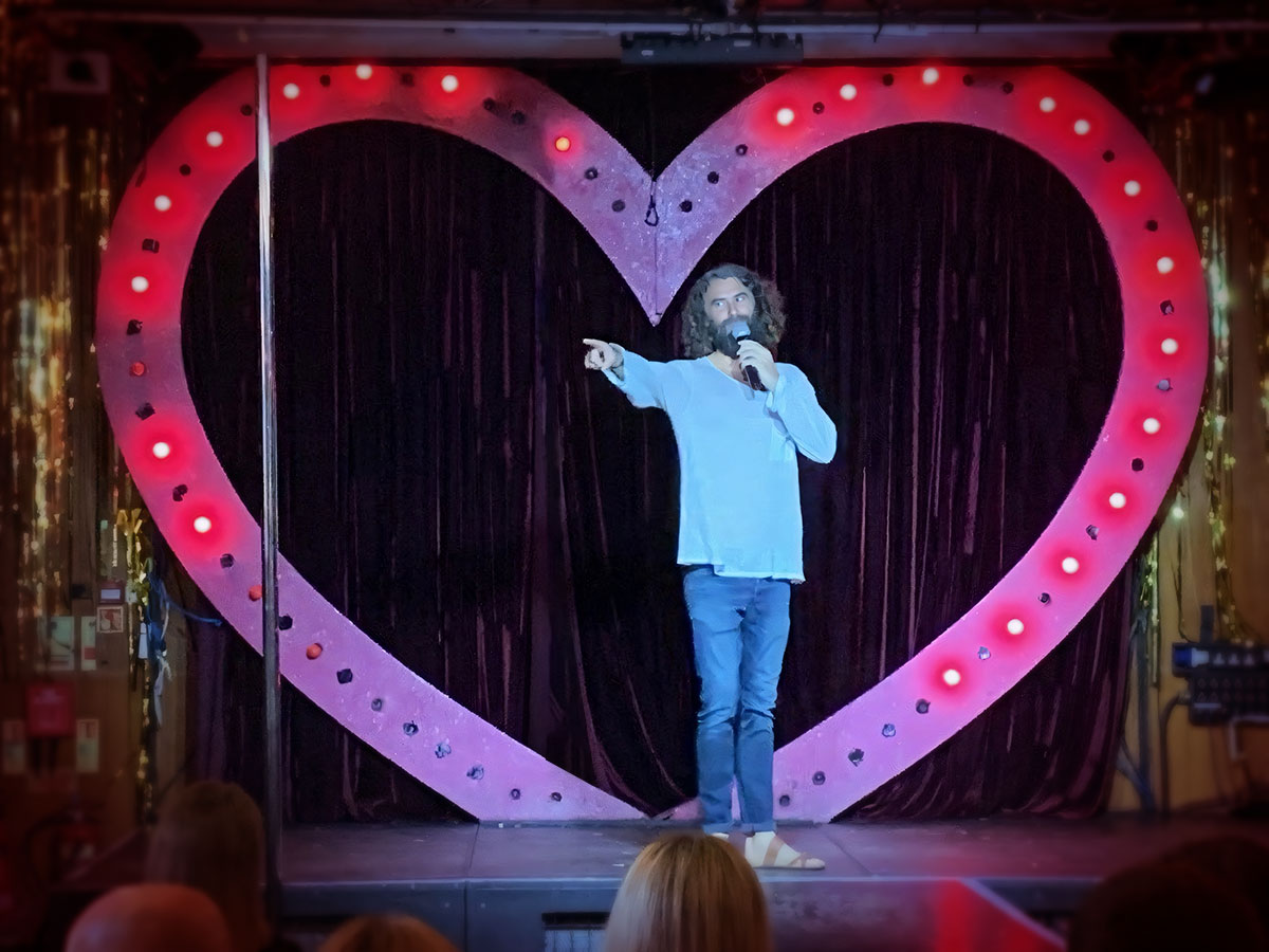 Photo of Danny on stage at the Presenting The Free Folk Project event. Bethnal Green, London July 2023